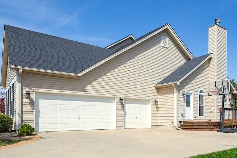 Above All Construction shares an image of a house with a striking roofline in a residential neighborhood.  The house displays an abutment at the garage that also has a chimney along the outer wall.