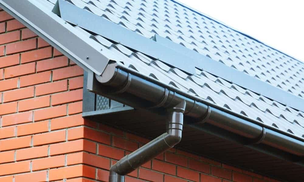 Above All Construction displays a home with new gutters and downspouts that they installed.