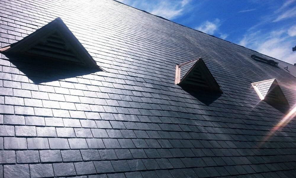 Above All Construction displays their capability in installing a commercial slate roof for Kansas City area business owners.